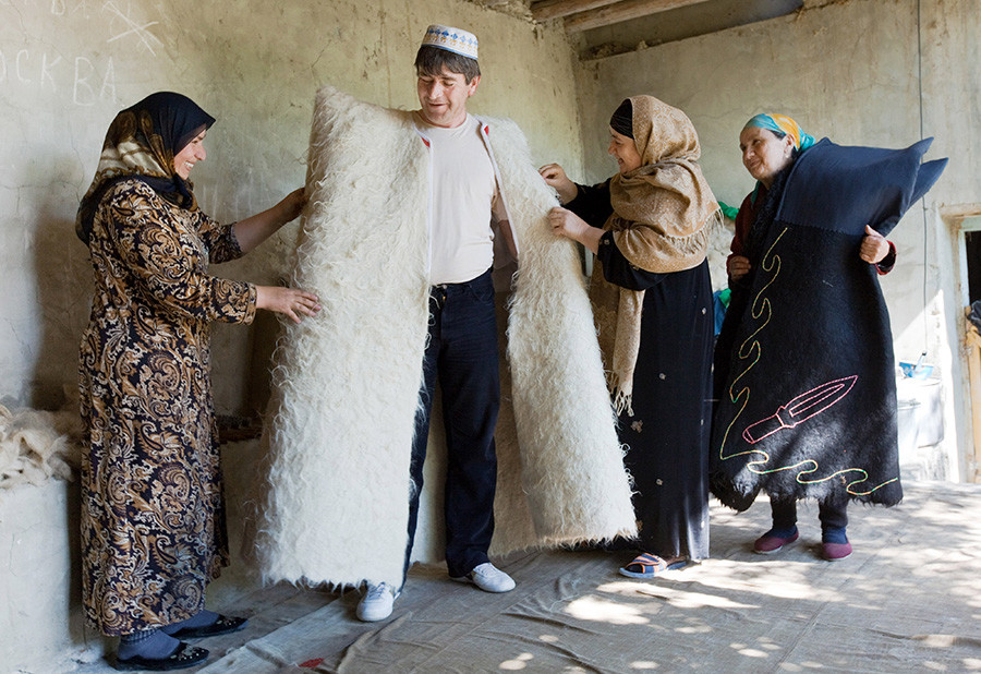 Примерка новой бурки. Женщины семьи Абуталиповых, живущие в дагестанской деревне Рахати, производят бурки – традиционную одежду людей, населяющих Кавказский регион. В этом ремесле занято лишь несколько семей на Кавказе.