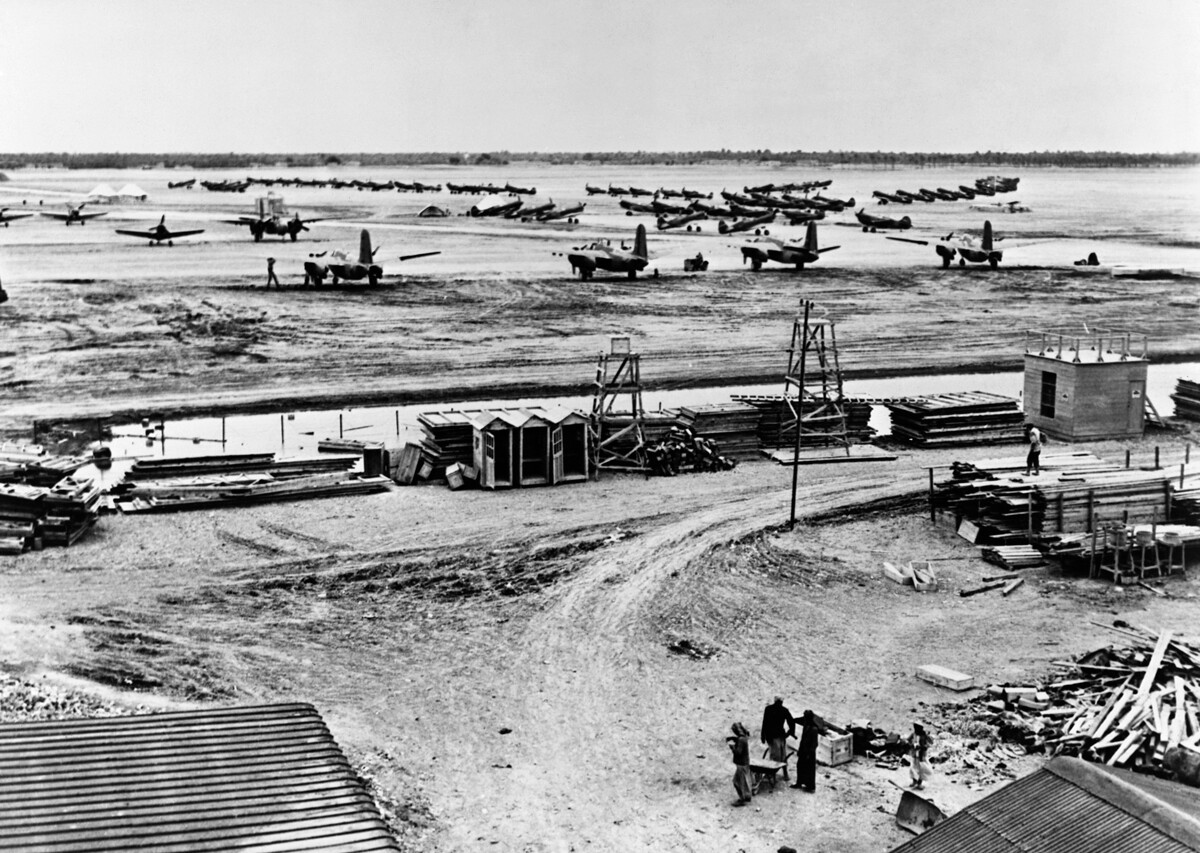 American lend-lease fighters and bombers on the ground at a delivery depot in Iran.