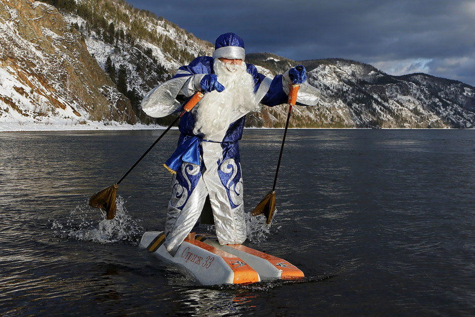 Nikolai Vasilyev, 62, dressed as Father Frost, Russian equivalent of Santa Claus, water-skis along the Yenisei River outside Siberian city of Krasnoyarsk, Russia. Vasilyev, a teacher of the Krasnoyarsk Aerospace Academy, constructed the self-made water skis to travel on the water surface. The skis are made of plastic foam and the sticks are designed to propel him forward.