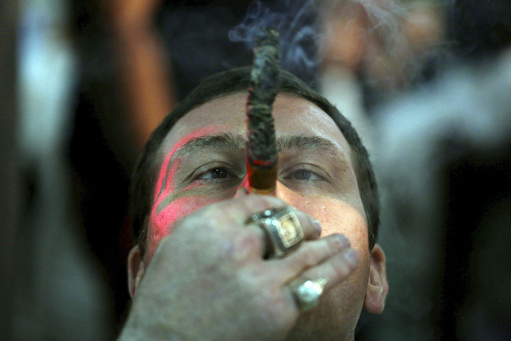 Actor Max Uralsky, from Russia, smokes as he competes for the longest ash during the XVIII Habanos Festival in Havana