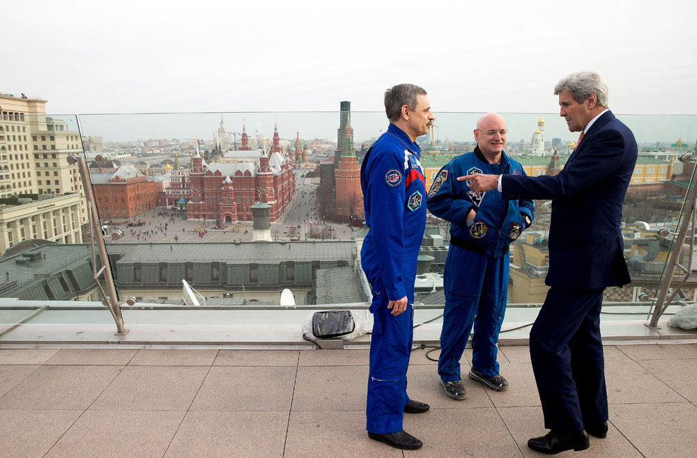 Red Square is visible in the background as Secretary of State John Kerry meets with American astronaut Scott Kelly, second from right, and Russian cosmonaut Mikhail Korniyenko on the roof of the Ritz-Carlton Hotel in Moscow, Russia
