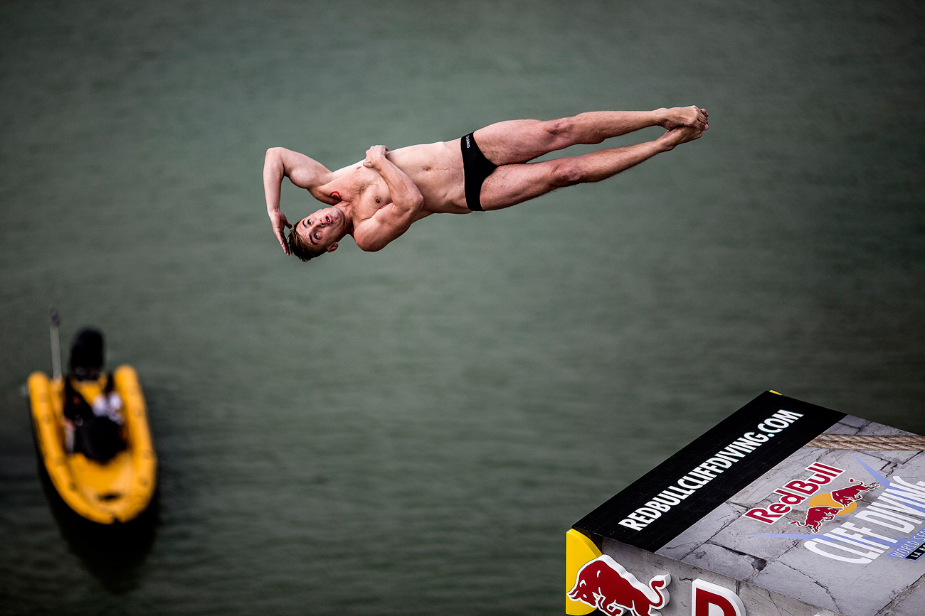  In this handout image provided by Red Bull, Artem Silchenko of Russia dives from the 27 metre platform on the Saint Nicolas Tower during the first training session of the fourth stop of the Red Bull Cliff Diving World Series, La Rochelle, France