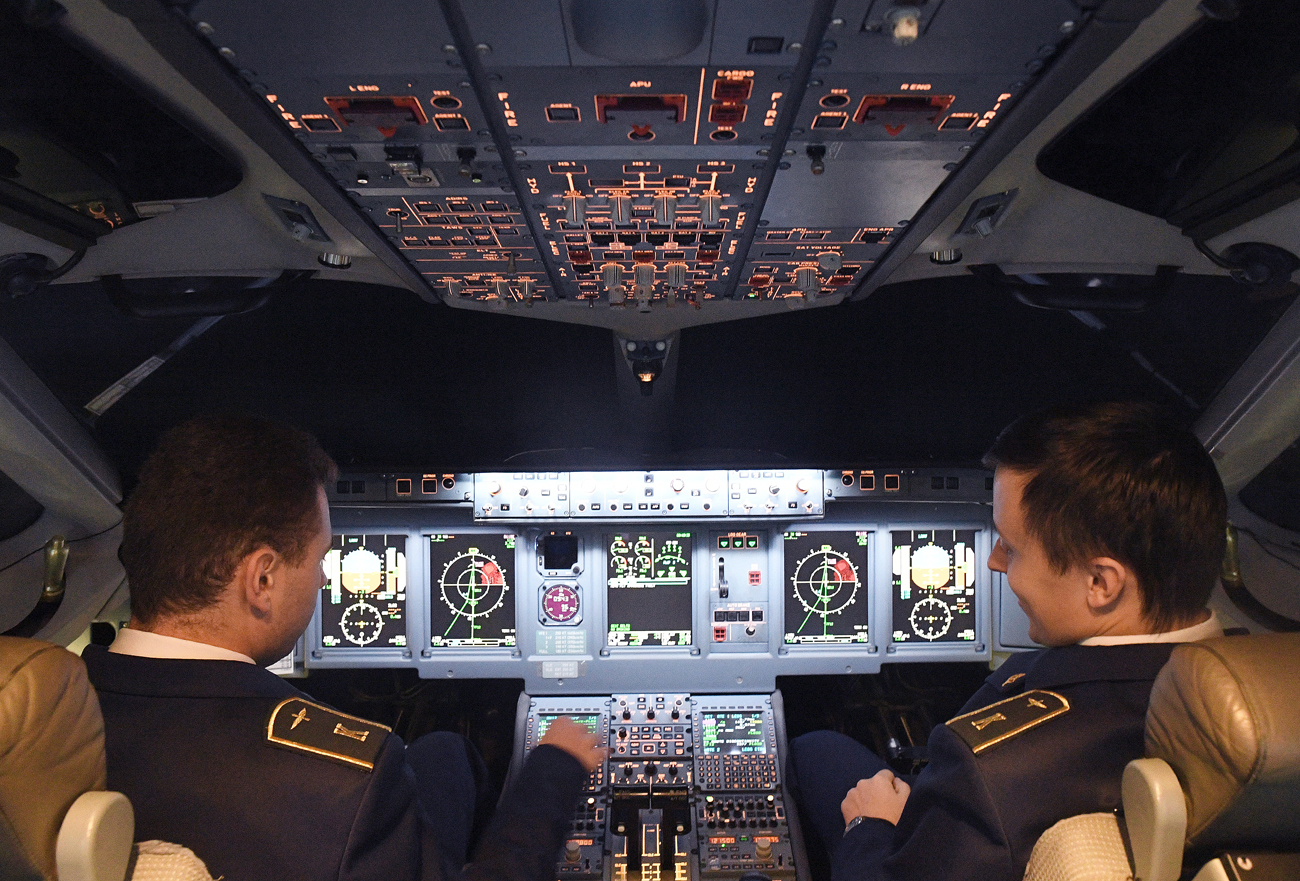 Participants in the Sukhoi Superjet 100 piloting contest 'The Best in the Sky' in the cockpit of a SSJ-100 Full Flight Simulator (FFS) in Aeroflot's Water-Land training facility at Sheremetyevo Airport