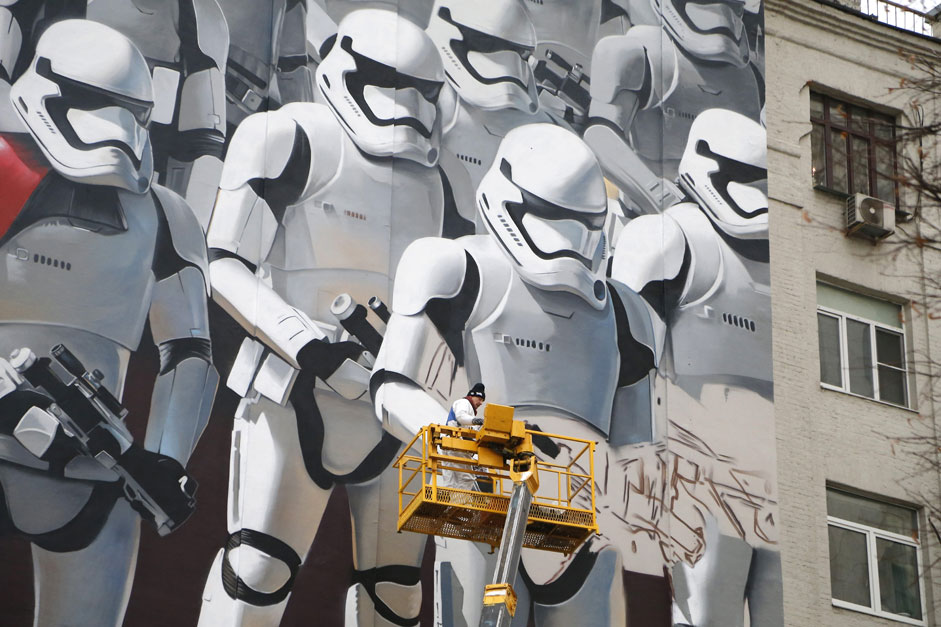 Artist Artur Kashak paints a graffiti depicting stormtroopers of the Imperial armed forces from the Star Wars movie series on a wall of a house in Moscow, Russia. Kashak is creating his work on the occasion of upcoming Russian premiere of the franchise's new movie, 'Star Wars Episode VII: The Force Awakens'.